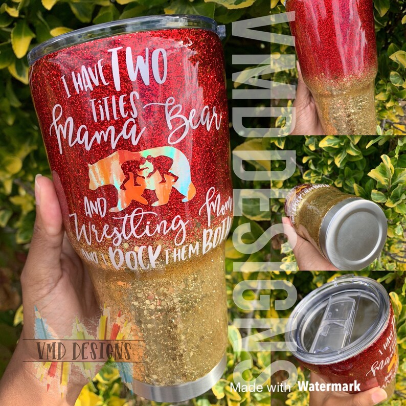 May include: A red and gold glitter tumbler with the text "I have two titles Mama Bear and Wrestling I rock them both". The tumbler features a bear and cubs graphic.
