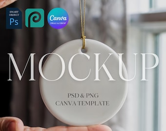 May include: A white ceramic round ornament with a gold string, held by a hand. The word "MOCKUP" is printed on the ornament. Below the word are the words "PSD & PNG" and "CANVA TEMPLATE".