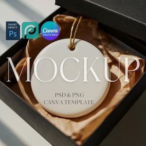 May include: A white ceramic ornament mockup with a gold string, inside a black box with brown paper. The word "MOCKUP" is printed on the ornament. The text "PSD & PNG CANVA TEMPLATE" is also visible.