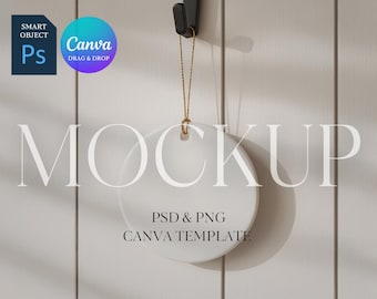 May include: A white, round ceramic ornament mockup hanging from a black hook with a gold string. The text "MOCKUP" is displayed in large, light gray letters. Below, the text reads "PSD & PNG CANVA TEMPLATE".