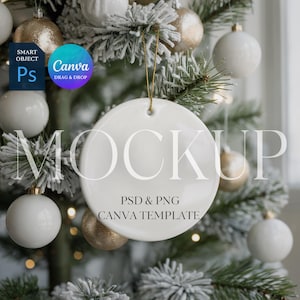 May include: A white ceramic round ornament mockup with a gold string, hanging on a Christmas tree. The ornament has the word "MOCKUP" printed on it, along with "PSD & PNG" and "CANVA TEMPLATE". The tree is decorated with white and gold ornaments.
