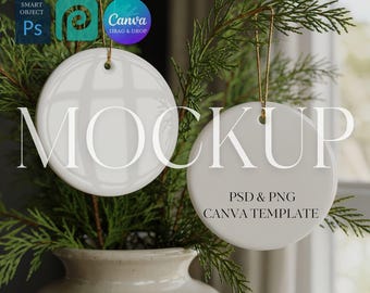 May include: Two white ceramic round ornaments hanging from gold strings, with the word "MOCKUP" in large letters. The ornaments are in front of a green plant in a beige vase. Text on the ornaments reads "PSD & PNG CANVA TEMPLATE".
