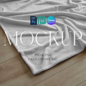 May include: A white blanket mockup with the word "MOCKUP" in large, elegant font. The image includes the text "PSD & PNG CANVA TEMPLATE" and logos for Photoshop and Canva, set against a wooden background.