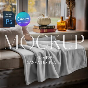 May include: A soft, light gray blanket draped over a window seat, with the word "MOCKUP" in large white letters. The scene includes a white pumpkin, books, and decorative bottles, suggesting a cozy, autumnal theme. The image also includes the text "PSD & PNG CANVA TEMPLATE".