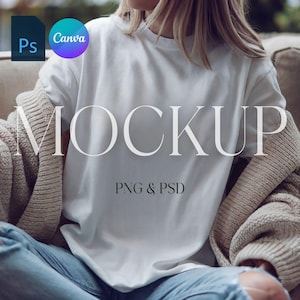 May include: A white t-shirt mockup with the word "MOCKUP" and the text "PNG & PSD" on the front. The t-shirt is being worn by a person sitting on a couch.