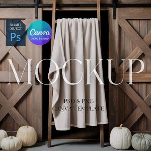 May include: A beige blanket draped over a wooden ladder against a backdrop of rustic wooden doors. The word "MOCKUP" is prominently displayed, with text indicating a PSD & PNG Canva template. White pumpkins are arranged at the base.