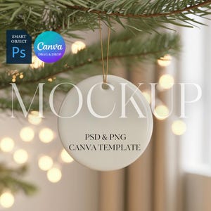 May include: A white, circular Christmas bauble mockup suspended by a gold string from a green pine branch. The bauble features the word "MOCKUP" and the text "PSD & PNG CANVA TEMPLATE".