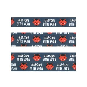 May include: Three strips of patterned paper with a dark blue background. The pattern features a cartoon devil face with the text "HANDSOME LITTLE DEVIL" in white. The devil has red skin, black horns, and a smiling expression.