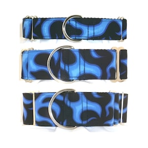 May include: Three blue and black flame patterned dog collars with silver metal hardware. The collars are shown in different sizes.