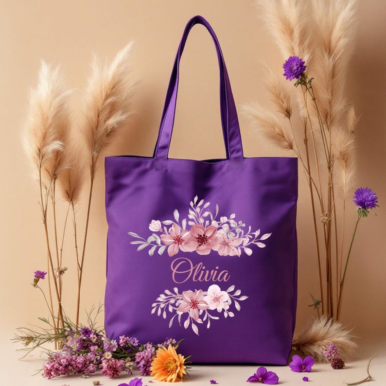 May include: Purple tote bag with a floral design and the name "Olivia" printed on it.