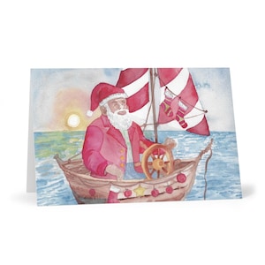 帆船に乗った黒いサンタのカード – 海辺のクリスマスグリーティング – 太陽の下での休日
