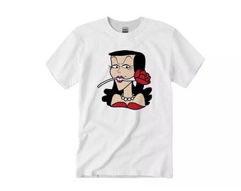 May include: White t-shirt with a cartoon illustration of a woman with black hair, red lipstick, and a red rose in her mouth. The woman is wearing a red dress and a pearl necklace.