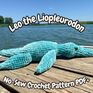 May include: A teal plush Liopleurodon toy with a soft, textured surface, dark eyes, and a wide mouth. The text Leo the Liopleurodon and No-Sew Crochet Pattern PDF is displayed in white with a black outline above and below the plush creature.