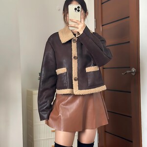 Vintage Aviator Jacket, 70s Style Jacket, Women’s Shearling Bomber, Brown B3 Jacket, Sheepskin Flight Jacket, Fur Collar Jacket, Leather Bomber Jacket Women, Winter Pilot Jacket, Cozy Sheepskin Coat, Retro Flight Coat, 1970s Aviation Style, Bomber Coat with Fur, Real Sheepskin Jacket, Women’s Vintage Outerwear, Classic Leather Bomber, Winter Leather Jacket, Warm Shearling Coat, Retro Brown Jacket, Fur Lined Bomber, B3 Leather Jacket, Timeless Flight Jacket, Brown Aviator Coat, Winter Fashion