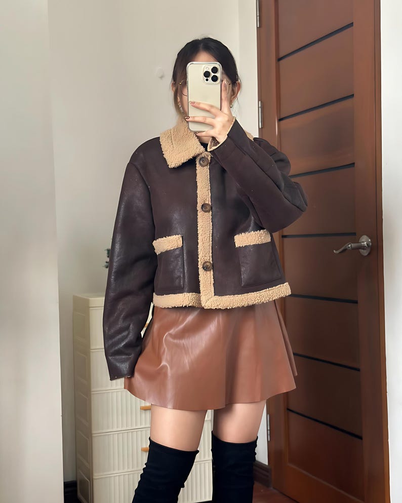 Vintage Aviator Jacket, 70s Style Jacket, Women’s Shearling Bomber, Brown B3 Jacket, Sheepskin Flight Jacket, Fur Collar Jacket, Leather Bomber Jacket Women, Winter Pilot Jacket, Cozy Sheepskin Coat, Retro Flight Coat, 1970s Aviation Style, Bomber Coat with Fur, Real Sheepskin Jacket, Women’s Vintage Outerwear, Classic Leather Bomber, Winter Leather Jacket, Warm Shearling Coat, Retro Brown Jacket, Fur Lined Bomber, B3 Leather Jacket, Timeless Flight Jacket, Brown Aviator Coat, Winter Fashion
