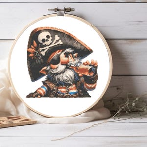 May include: A cross-stitch pattern of a cartoon pirate with a black and white skull and crossbones hat, a white beard, and a red and blue striped shirt. The pirate is holding a telescope to his eye.