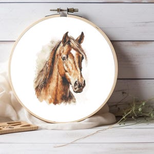 May include: A brown horse with a white star on its forehead, looking to the side. The horse's mane and tail are flowing in the wind. The background is a soft, watercolor-like wash of brown and white.