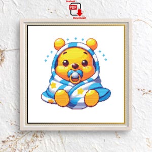 May include: A digital cross-stitch pattern featuring a cartoon bear character wrapped in a blue and white striped blanket. The bear has a pacifier and is surrounded by blue star accents. The image is framed and includes a "PDF Download" icon.