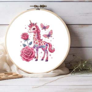 May include: A pink and white unicorn with a rainbow pattern and a gold horn stands on a white background with two pink roses and two pink butterflies.