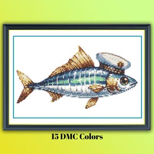 May include: Cross-stitch art of a fish wearing a sailor hat. The fish has blue, green, and gold scales, with a detailed fin and tail. The artwork is framed in a black frame, with the text "15 DMC Colors" at the bottom.