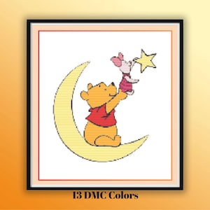 May include: A cross-stitch pattern featuring a yellow bear in a red shirt sitting on a yellow crescent moon, holding up a small pink piglet who is reaching for a yellow star. The design is framed by a thin red border and includes 13 DMC colors.
