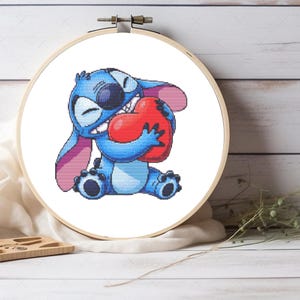May include: Blue Stitch character holding a red heart. Stitch is a cartoon character from the Disney movie Lilo & Stitch.
