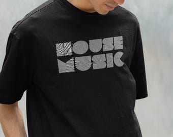 May include: Black t-shirt with the words "HOUSE MUSIC" in a white, wavy, geometric font. The shirt is a crew neck style. The text "©2025 Lit Vibe Rave Wear" is at the bottom of the shirt.