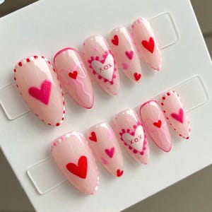 Hearts and bows Valentine’s Day nails | February nails | handmade press on nails | custom gel nails | trendy nails | pink and red nails