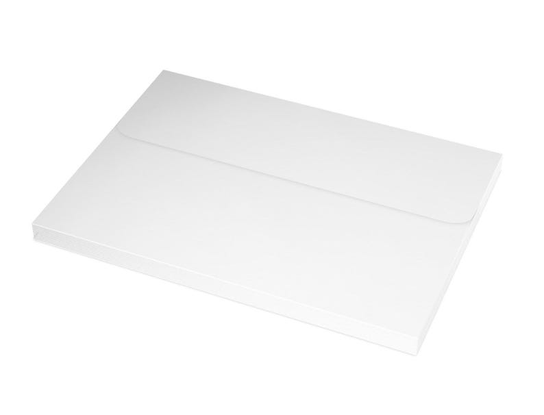 May include: A white envelope with a flap on the top. The envelope is lying flat on a white surface.