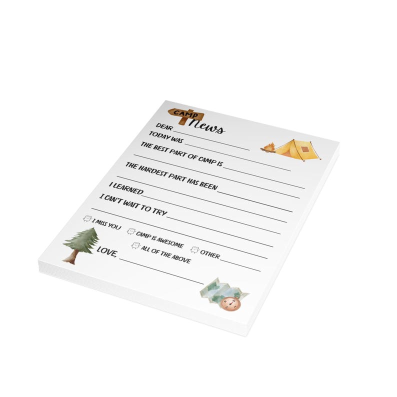 May include: A white notepad with a brown wooden sign that says "Camp News". The notepad has lines for writing and includes a drawing of a tent, a campfire, and a pine tree.