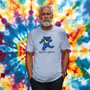 May include: A light blue t-shirt with a blue dancing bear graphic and the text "Grateful Grandpa".