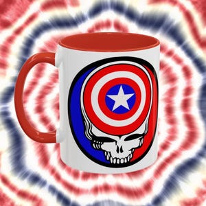 May include: White ceramic coffee mug with a red interior and handle. The mug features a graphic of a skull with the American flag inside the skull's head.