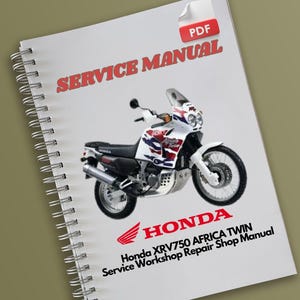 Op de afbeelding: Een witte Honda XRV750 Africa Twin motorfiets servicehandleiding met een rood Honda-logo en de woorden "Service Workshop Repair Shop Manual".