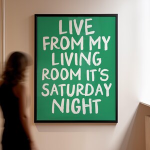 May include: A framed green poster with white text that reads "Live from my living room it's Saturday night".