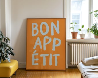 May include: A framed print with an orange background and the words "BON APPÉTIT" written in white.
