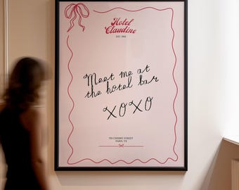 May include: A black framed poster with a pink background and red text. The poster says "Hotel Claudine Est. 1963" and "Meet me at the hotel bar XOXO 720 Cherry Street Paris, TX".