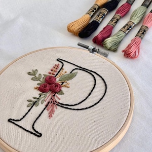 Floral monogram embroidery pattern featuring elegant letter designs with stitched flowers and leaves, full alphabet embroidery bundle A to Z, printable hand embroidery patterns, beginner friendly embroidery designs with step by step stitch guide and color references
