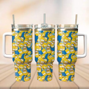 May include: Three stainless steel tumblers with a blue and yellow pattern of cartoon faces. The tumblers have a white handle and a gold rim. Each tumbler has a clear lid and a straw.