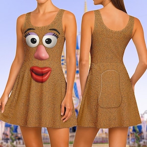 May include: Brown sleeveless dress featuring a cartoon face design. The dress has a textured appearance and a flared skirt. The front of the dress displays large eyes, a pink nose, and red lips. The back of the dress has a pocket-like design.