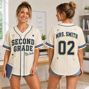 May include: A cream-colored baseball jersey with thin yellow pinstripes and navy blue trim. The front features the text "SECOND GRADE" and "Mrs. Smith" in navy blue. The back displays "MRS. SMITH" and the number "02" with gold star accents.