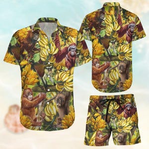 May include: A matching set of short-sleeved shirt and shorts. The set features a vibrant pattern of orangutans, monkeys, and bananas in shades of brown, yellow, and green. The shirt has a classic collar and button closure, while the shorts have a drawstring waist.