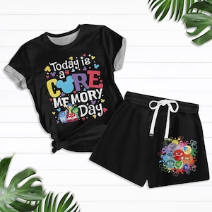 May include: Black and white pyjama set with a short-sleeved t-shirt and shorts. The t-shirt has a colourful graphic with the text "Today is a CORE MEMORY Day" and a Mickey Mouse head. The shorts have a colourful graphic of characters from the movie Inside Out.