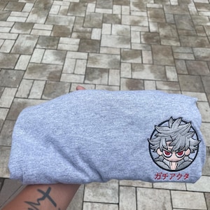 May include: A set of three ceramic mugs with a speckled, matte finish in cream, light grey, and dark grey. Each mug has a simple, minimalist design and a rounded handle.