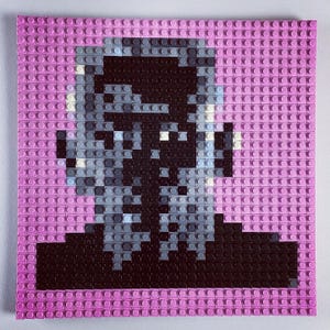 May include: A pixelated portrait of a person with a black and grey face, created using Lego bricks on a pink background.