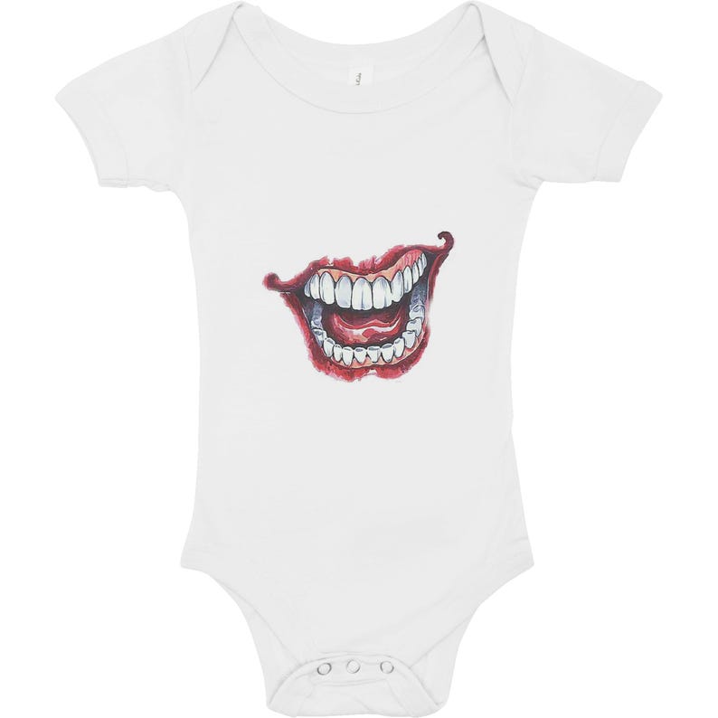 May include: White baby bodysuit featuring a detailed illustration of a wide, grinning mouth with red lips and visible teeth. The design is centered on the front of the short-sleeved onesie, creating a bold graphic.