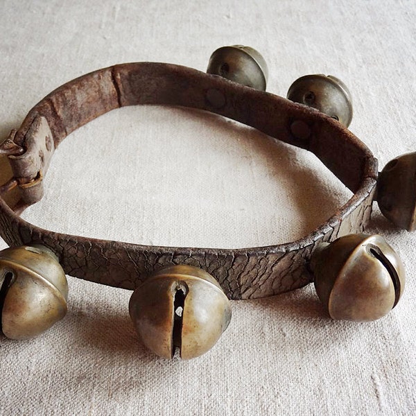 vintage sleigh bells on leather strap, 6 brass bells from an old horse sleigh harness