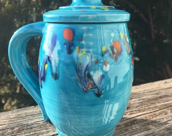 large covered mug, turquoise with colored crystals