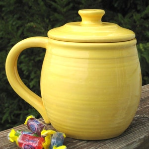 large covered mug, yellow