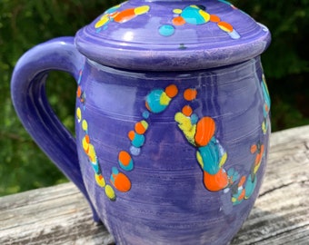 large covered mug, larkspur with colored crystals