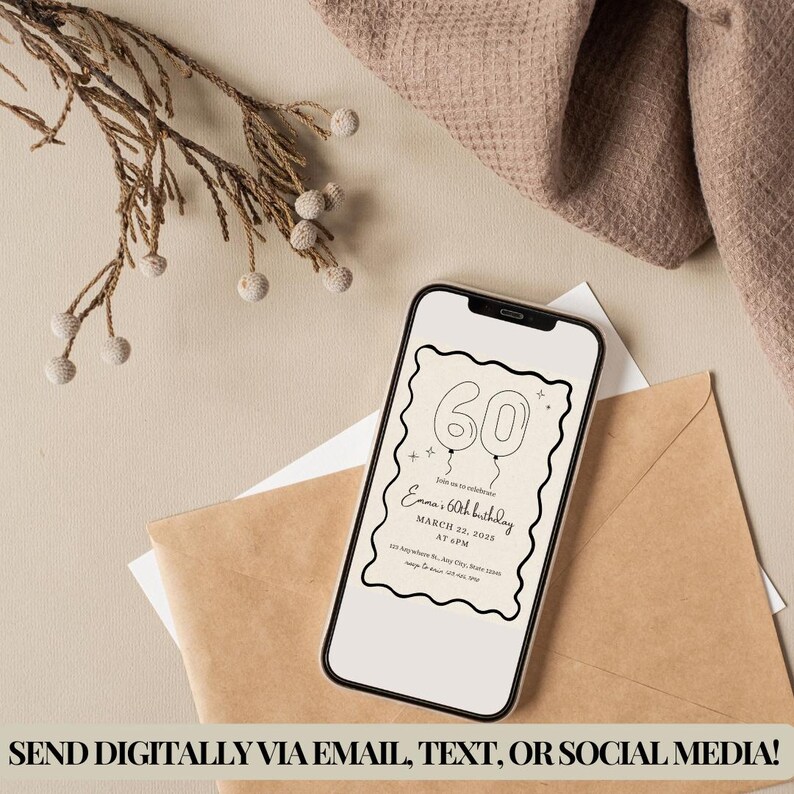 May include: A smartphone displays a digital 60th birthday invitation with balloon graphics. The invitation includes the text "Emma's 60th birthday, March 22, 2028, at 4 PM." The phone rests on a beige surface with an envelope and decorative sprig.